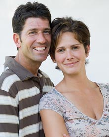 photo of a happy young couple - smiling because TMJ is no longer troubling them.